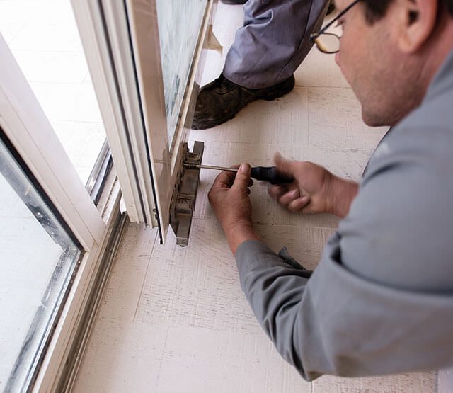 ALS - professional carpenters installing a balcony door
